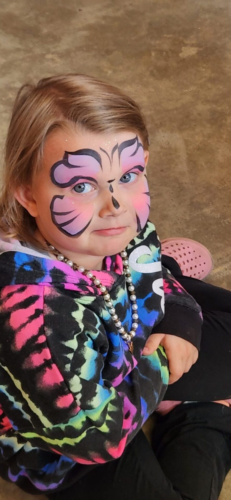 little girl with with flower in her face