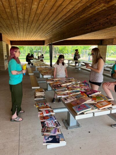 people looking a table with books