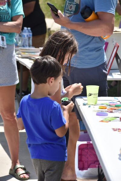 kids playing and eating cupcakes