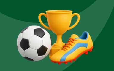 A soccer, trophy and soccer cleat